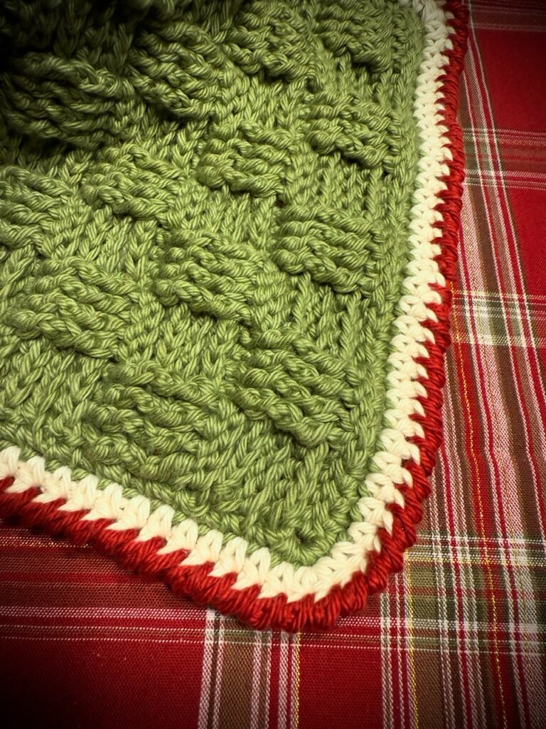 Close-up of a basket weave crochet dishcloth, highlighting the woven-like texture and intricate post stitches.